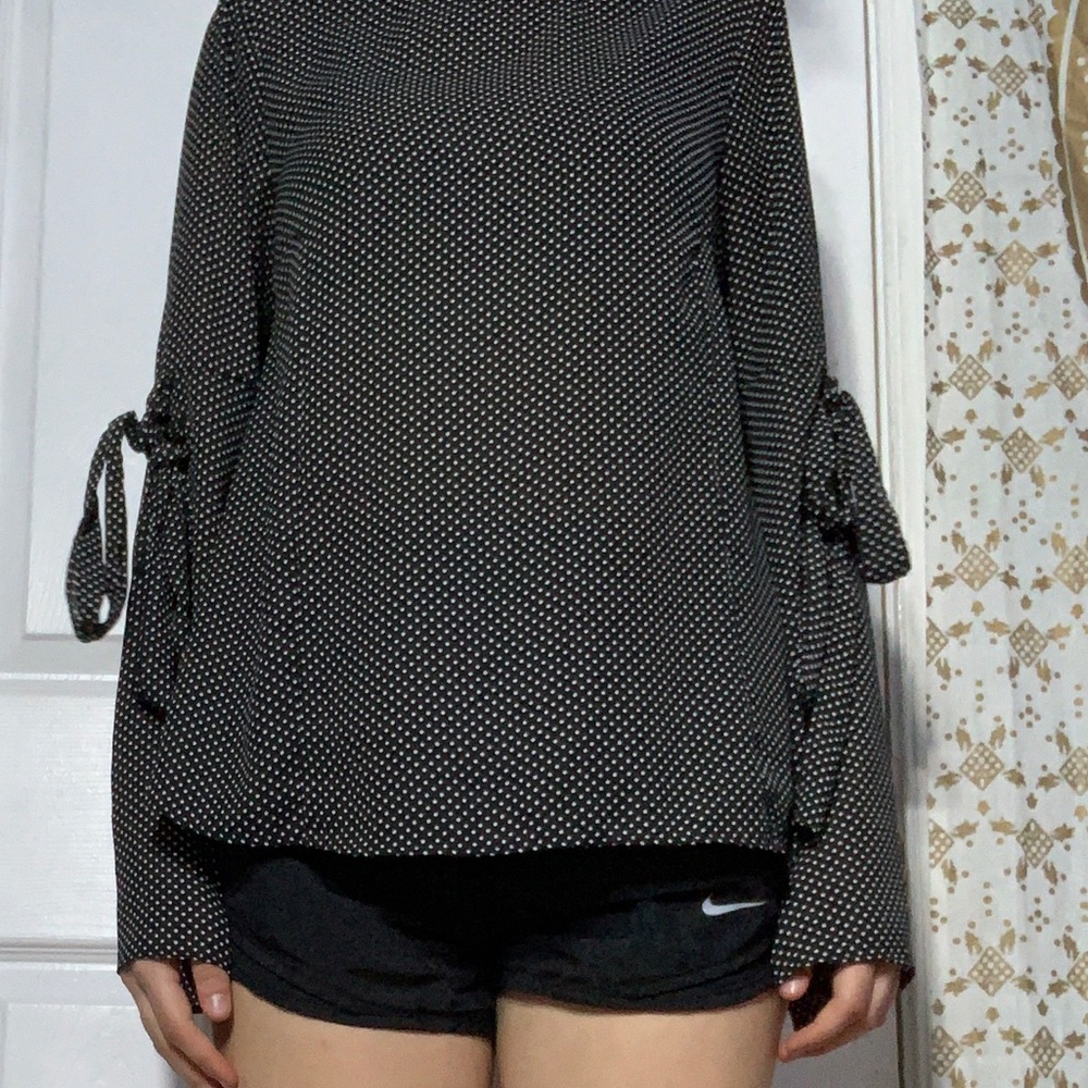 A black with white polka dot blouse